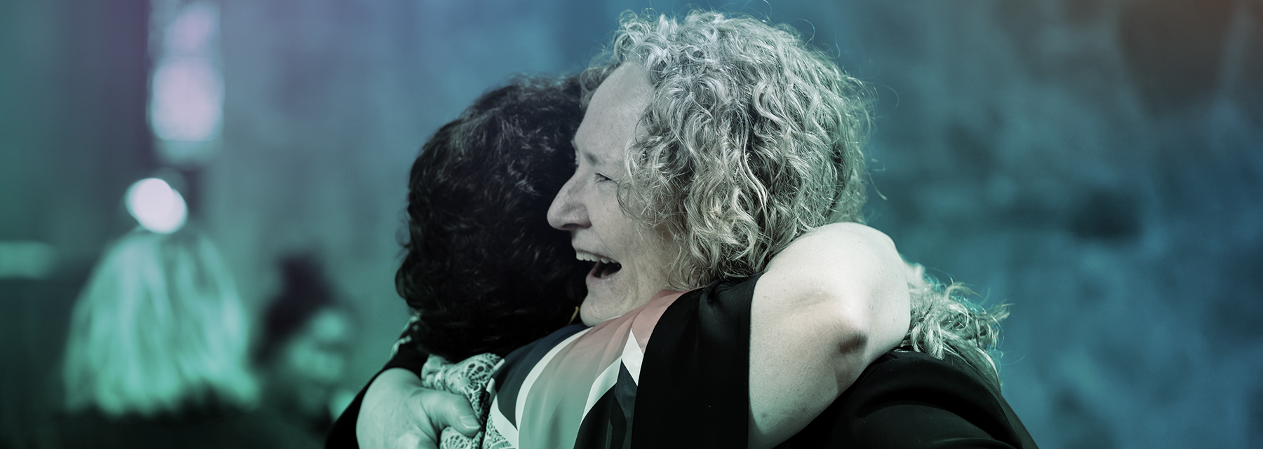 Two old girls embrace at BSS reunion.
