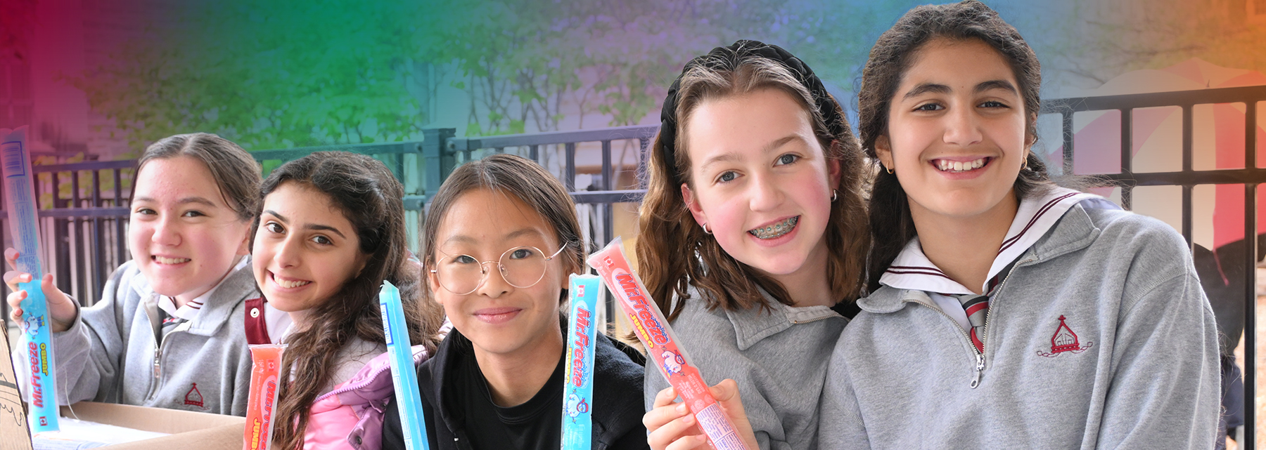 Five BSS middle school students are lined up eating freezies.